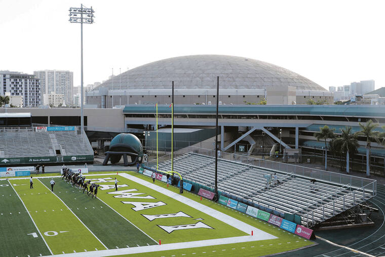 JAMM AQUINO / JAQUINO@STARADVERTISER.COM
                                The Hawaii Rainbow Warriors warmed up surrounded by fanless bleachers for an NCAA football game against the Portland State Vikings on Saturday at the Ching Complex.