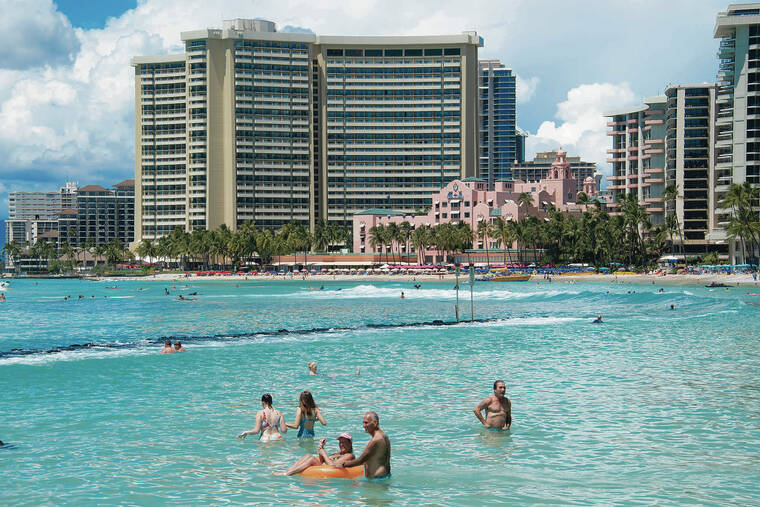 CRAIG T. KOJIMA / CKOJIMA@STARADVERTISER.COM
                                Since Gov. David Ige’s request to tourists in August to postpone visiting Hawaii until October, fewer beachgoers have visited Waikiki Beach, above, and hotel occupancy has dropped.
