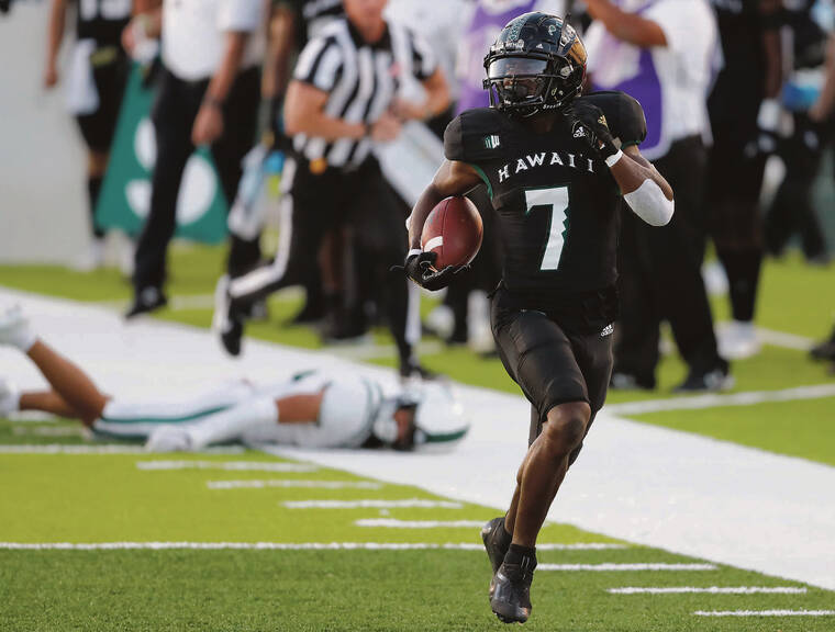 JAMM AQUINO/JAQUINO@STARADVERTISER.COM
                                Hawaii running back Calvin Turner dashes toward the end zone for a touchdown against the Portland State Vikings during the first half,
