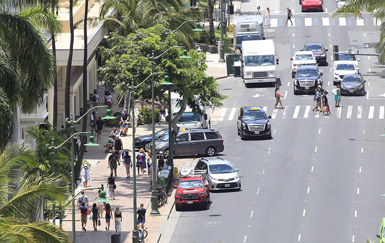 JAMM AQUINO / APRIL 26
                                Pedestrian and vehicular traffic is seen on Kalakaua Boulevard in Waikiki earlier this year.
