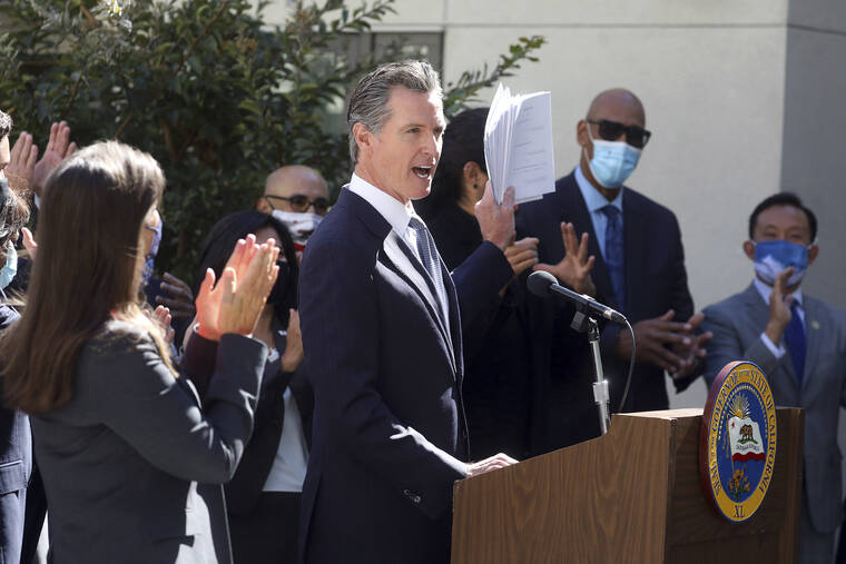 BAY AREA NEWS GROUP VIA AP
                                California Gov. Gavin Newsom, shown speaking at a news conference in Oakland, Calif. on Tuesday, announced the nation’s first <a href="https://www.staradvertiser.com/coronavirus/" target="_blank">coronavirus</a> vaccination mandate for schoolchildren today.