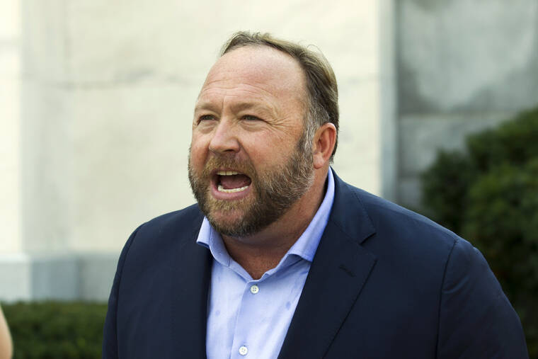 ASSOCIATED PRESS
                                Infowars host and conspiracy theorist Alex Jones speaks outside of the Dirksen building on Capitol Hill in Washington in 2018. A Texas judge has found Jones liable for damages in three defamation lawsuits brought by the parents of two children killed in the Sandy Hook Elementary School massacre over his claims that the shooting was a hoax.