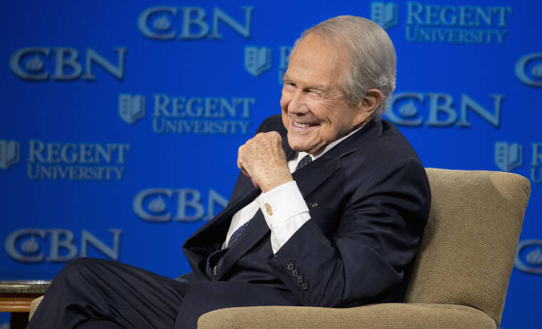 ASSOCIATED PRESS
                                Rev. Pat Robertson listens as Republican presidential candidate Donald Trump speaks at Regent University in Virginia Beach, Va., in 2016. The Christian Broadcasting Network says Pat Robertson is stepping down as host of the long-running daily television show the “700 Club.” Robertson said in a statement that his last time hosting the network’s flagship program was today.