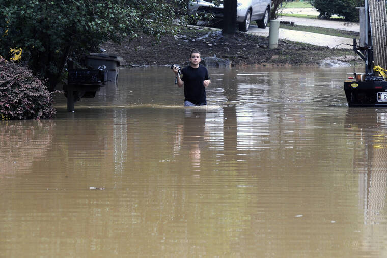 ASSOCIATED PRESS
                                Michael Halbert waded through his flooded neighborhood in Pelham, Ala., today. Terrified drivers climbed out of swamped cars and muddy floodwater flowed through neighborhoods after a stalled weather front drenched Alabama for hours, leaving entire communities underwater today and killing at least four people.