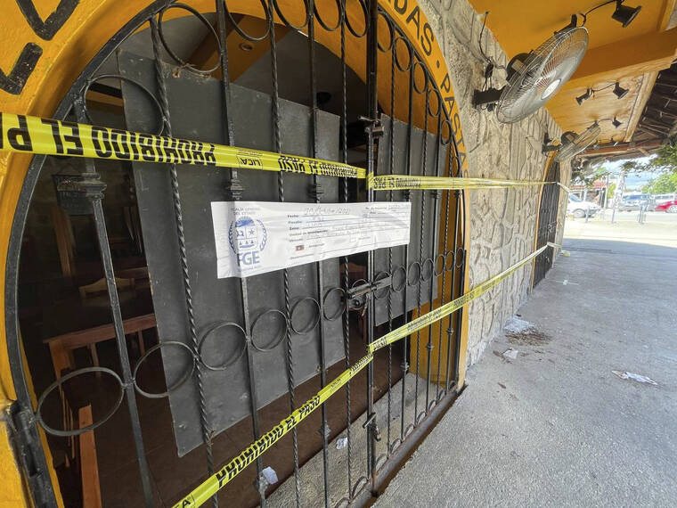 ASSOCIATED PRESS / OCT. 22
                                Police security tape covers the entrance of a restaurant the day after a fatal shooting in Tulum, Mexico. Two foreigners were killed and three wounded in a shooting in the Mexican Caribbean resort town of Tulum.