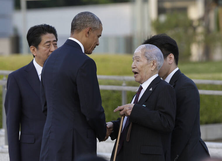ASSOCIATED PRESS / MAY 27, 2016
                                Sunao Tsuboi, right, a survivor of the 1945 Atomic Bombing and chairman of the Hiroshima Prefectural Confederation of A-bomb Sufferers Organization, talks with then-President Barack Obama, center, accompanied by then Japanese Prime Minister Shinzo Abe, left, at Hiroshima Peace Memorial Park in Hiroshima, western Japan in 2016. Tsuboi, a survivor of the Hiroshima atomic bombing, who made opposing nuclear weapons the message of his life, has died at age 96.