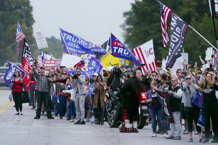 ASSOCIATED PRESS / OCT. 5
                                People protest as the motorcade for President Joe Biden passes by Oct. 5 in Howell, Mich.