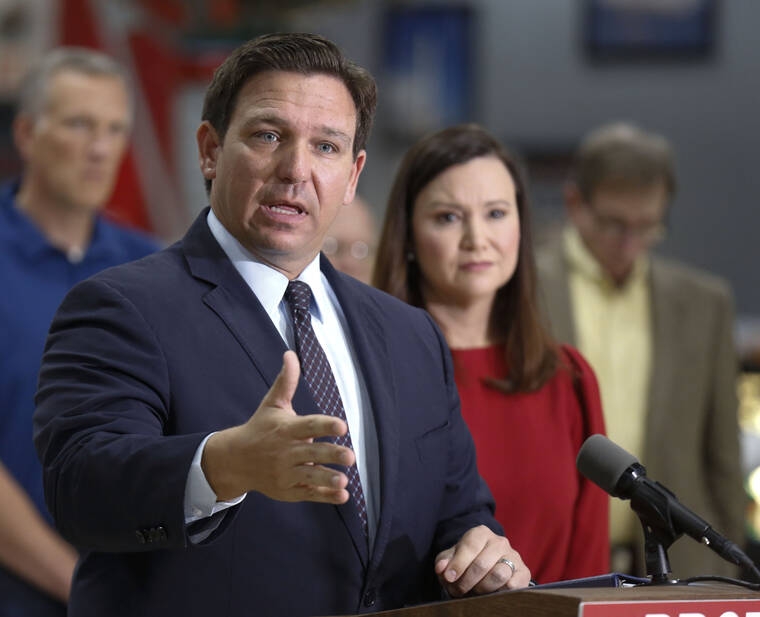 THE LEDGER VIA AP
                                Florida Gov. Ron DeSantis flanked by state Attorney General Ashley Moody and supporters addresses the media Thursday in Lakeland Fla.