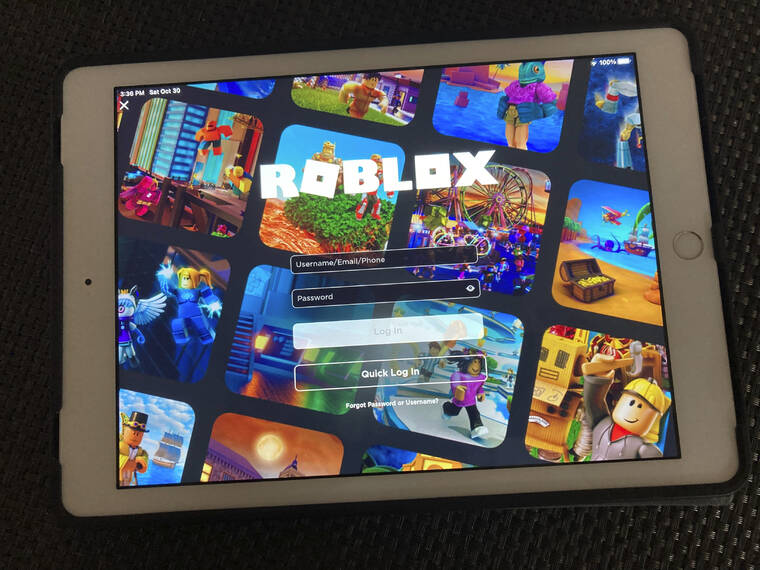 ASSOCIATED PRESS
                                The gaming platform Roblox is displayed on a tablet today in New York. The popular gaming platform crashed Friday and the company was still trying to restore service today.