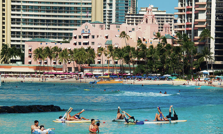 CRAIG T. KOJIMA / CKOJIMA@STARADVERTISER.COM
                                New data showed statewide hotel occupancy in September dropped to 55.2%, the lowest occupancy since April. People participated in a yoga class on surfboards Friday as others enjoyed Waikiki Beach.