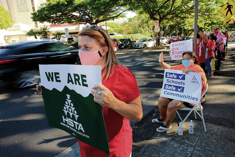 JAMM AQUINO / JAQUINO@STARADVERTISER.COM
                                Farrington High School special education teacher Inger Stonehill, left, joined HSTA supporters as they waved to passing motorists on Wednesday.