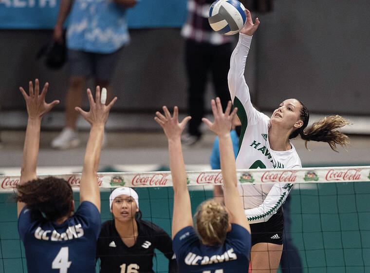 GEORGE F. LEE / GLEE@STARADVERTISER.COM
                                Hawaii’s Riley Wagoner went up for a kill against Josephine Ough and Perri Starkey of UC Davis on Friday.