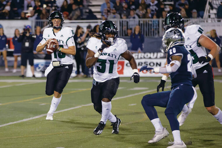 ASSOCIATED PRESS
                                UH quarterback Brayden Schager rolled out to pass against Nevada on Saturday in Reno, Nev.
