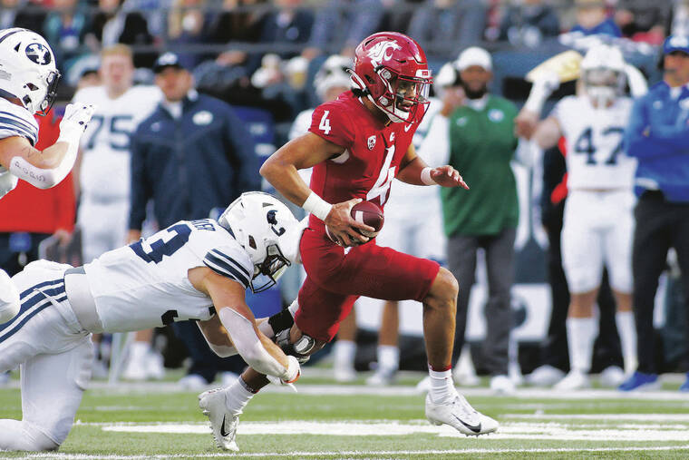 ASSOCIATED PRESS
                                Washington State quarterback Jayden de Laura, right, carries the ball while defended by BYU linebacker Ben Bywater during the second half.