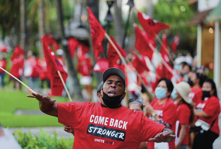 JAMM AQUINO / JAQUINO@STARADVERTISER.COM
                                Above, Local 5 member Bennie Rambin chanted with hundreds of fellow Local 5 union members outside the Royal Hawaiian Center.