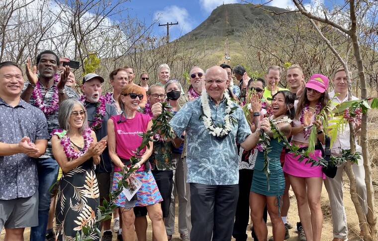 COURTESY CITY AND COUNTY OF HONOLULU
                                Honolulu Mayor Rick Blangiardi, along with city officials and members of the Kokonut Koalition, helped to untie a maile lei at the foot of Koko Crater Stairs after a blessing to commemorate the completion of repairs to the steps of the popular hike.