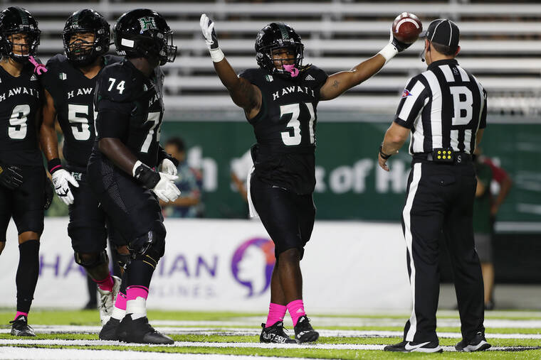 GEORGE F. LEE / GLEE@STARADVERTISER.COM
                                University of Hawaii’s Dedrick Parson celebrated his touchdown against the New Mexico State Aggies.