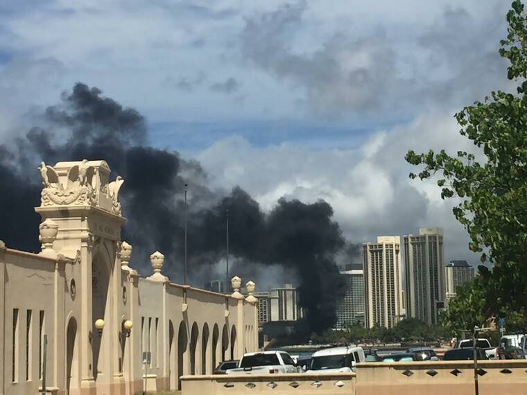 COURTESY NANCY ARCAYNA
                                Smoke can be seen billowing from a fire reported at 2425 Kalakaua Avenue in Waikiki this morning.