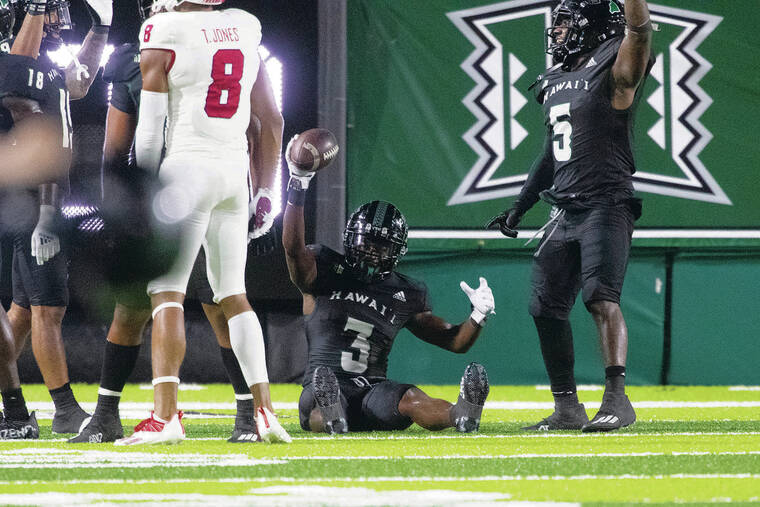 GEORGE F. LEE / GLEE@STARADVERTISER.COM
                                UH’s Hugh Nelson II held up his interception that sealed the Rainbow Warriors’ victory over No. 18 Fresno State on Saturday at the Clarence T.C. Ching Complex.