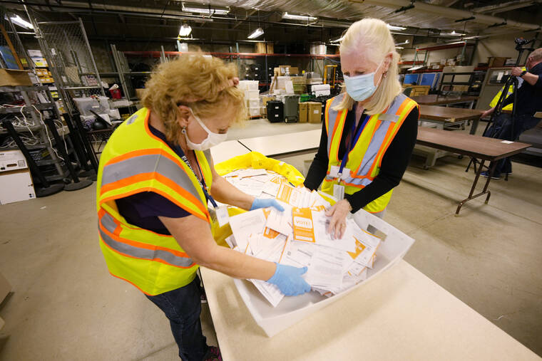 ASSOCIATED PRESS
                                Election judges Violet Wellborn, left, and Valerie Hayes-Aneage process early ballots in the Jefferson County elections division, Tuesday in Golden, Colo. Officials were highlighting the steps taken to ensure that the election is carried out seamlessly.
