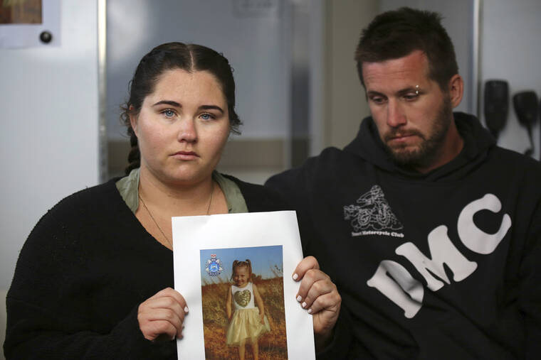 JAMES CARMODY/AAP IMAGE/POOL VIA AP / OCT. 19
                                Ellie Smith, left, and her partner Jake Gliddon, display a photo of their missing daughter, Cleo, near Carnarvon in Western Australia state, Australia. Cleo was rescued “alive and well” on Wednesday, Nov. 3, more than three weeks after she was suspected to have been snatched from a tent during a family camping trip on Australia’s remote west coast, police said.
