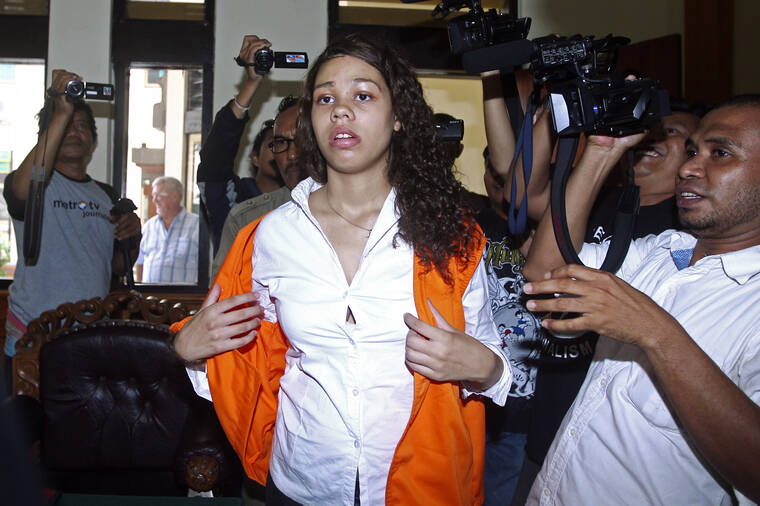ASSOCIATED PRESS / 2015
                                Heather Mack of Chicago, Ill., center, is mobbed by reporters as she arrives in the courtroom for her sentencing hearing at a district court in Denpasar, Bali, Indonesia. Mack, who served more than seven years in an Indonesian prison for killing her mother at a luxury resort in Bali has been indicted on federal murder conspiracy charges and taken into custody by FBI agents at O’Hare International Airport in Chicago on Wednesday Nov. 3.