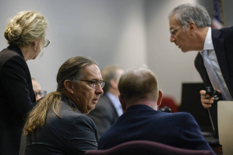 OCTAVIO JONES/POOL PHOTO VIA AP / OCT. 27
                                Defense attorney Franklin Hogue, center left, interacts with Travis McMichael at the jury selection in the trial of McMichael, William “Roddie” Bryan, and Gregory McMichael, charged with the February 2020 death of 25-year-old Ahmaud Arbery, at the Gwynn County Superior Court, in Brunswick, Ga.