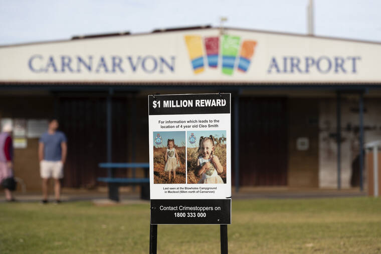 RICHARD WAINWRIGHT/AAP IMAGE VIA AP
                                A poster offering a $1 million reward for information about the missing 4-year-old girl Cleo Smith stands outside the Carnarvon airport, 900km (560 miles) north of Perth, Australia.