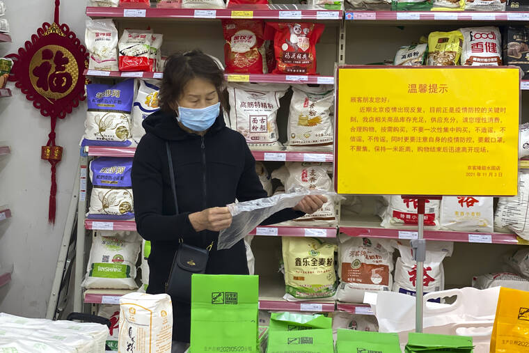 ASSOCIATED PRESS
                                A woman wearing a mask shopped near a sign which calls for shoppers to be vigilant against the coronavirus rebounding and not to listen to rumors and to avoid stockpiling at a supermarket in Beijing, China, Wednesday. A recent seemingly innocuous government recommendation for Chinese people to store necessities for an emergency quickly sparked scattered instances of panic-buying and online speculation of imminent war with Taiwan.