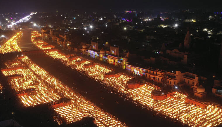 ASSOCIATED PRESS
                                People light lamps on the banks of the river Saryu in Ayodhya, India, on Wednesday.