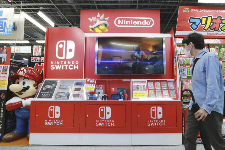 ASSOCIATED PRESS
                                A man walks by Switch from Nintendo at an electronics retail chain store in Tokyo on Oct. 13. The shortage in computer chips needed to make the Nintendo Switch machine continues to be a serious problem without prospects for a quick fix, the Japanese video-game maker’s president, Shuntaro Furukawa, said this week.