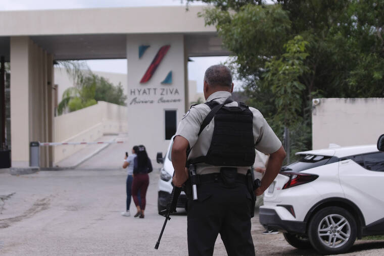ASSOCIATED PRESS
                                Government forces guard the entrance of hotel after an armed confrontation near Puerto Morelos, Mexico, today. Two suspected drug dealers were killed after gunmen from competing gangs staged a dramatic shootout near upscale hotels that sent foreign tourists scrambling for cover.