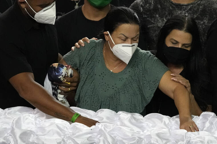 ASSOCIATED PRESS
                                Supported by security guards, Ruth Dias places her hand in the casket that contain the remains of her daughter, Brazilian singer Marilia Mendonca, during a wake at the Ginasio Arena in Goiania, Brazil. One of Brazil’s most popular singers and a Latin Grammy winner, Mendoca died Friday in an airplane crash on her way to a concert. She was 26.