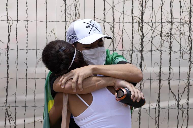 ASSOCIATED PRESS
                                Two people hug each other as fans wait in line for access to the wake of Brazilian singer Marilia Mendonca, in front of the Ginasio Arena in the city of Goiania, Brazil. One of Brazil’s most popular singers and a Latin Grammy winner, Mendonca died on Friday, Nov. 5, in an airplane crash on her way to a concert in the southeastern Brazilian of state Minas Gerais. Mendonça was 26 and performed country music in Brazil called sertanejo.