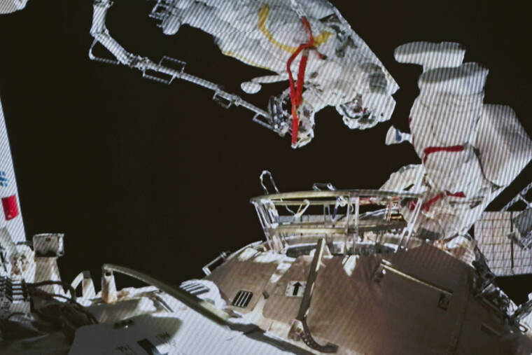 GUO ZHONGZHENG/XINHUA VIA ASSOCIATED PRESS
                                A photo taken on a screen shows Chinese astronauts Zhai Zhigang and Wang Yaping conducting extravehicular activities outside the space station’s Tianhe core module, from the Beijing Aerospace Control Center on Sunday. Wang Yaping has become the first Chinese woman to conduct a spacewalk as part of a six-month mission to the country’s space station.