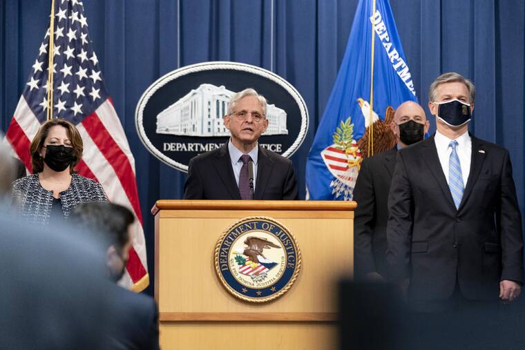 ASSOCIATED PRESS
                                Attorney General Merrick Garland, center, accompanied by Deputy Attorney General Lisa Monaco, left, and FBI Director Christopher Wray, right, speaks at a news conference at the Justice Department in Washington today.