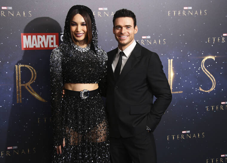 ASSOCIATED PRESS
                                Gemma Chan, left, and Richard Madden pose for photographers upon arrival at the premiere of the film ‘Eternals’ on Oct. 27 in London.