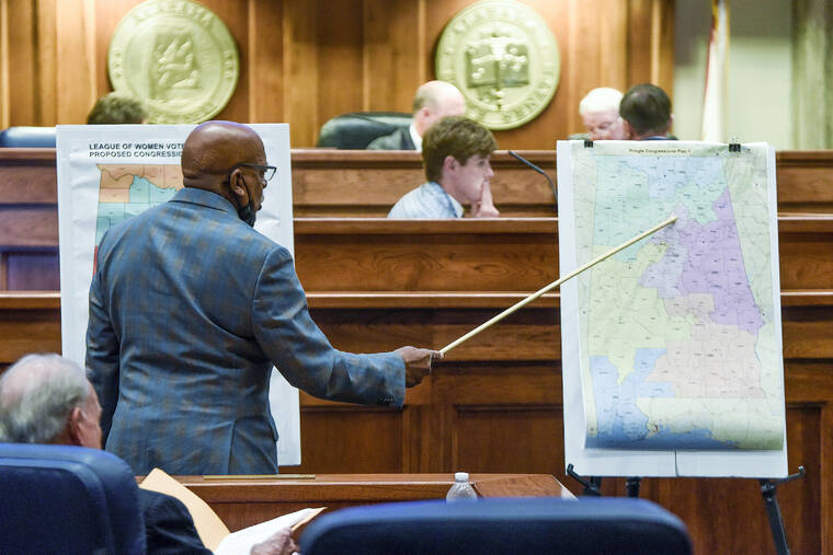 THE MONTGOMERY ADVERTISER VIA AP
                                Sen. Rodger Smitherman compares U.S. Representative district maps during the special session on redistricting at the Alabama Statehouse in Montgomery, Ala., on Nov. 3.