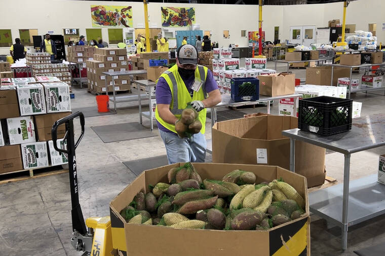 ASSOCIATED PRESS
                                A worker put bags of sweet potatoes in a container in the warehouse of the Alameda County Community Food Bank in Oakland, Calif., on Nov. 5. Inflation is starting to look like that unexpected — and unwanted — houseguest who just won’t leave.