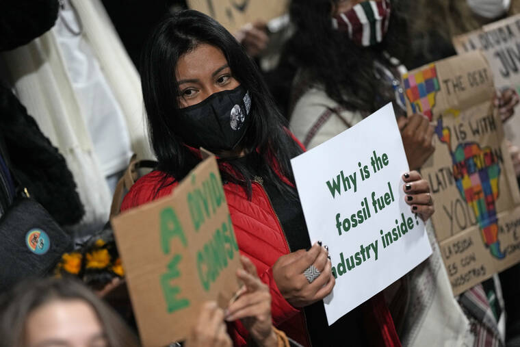 ASSOCIATED PRESS
                                Youth climate activists protest that representatives of the fossil fuel industry have been allowed inside the venue during the COP26 U.N. Climate Summit in Glasgow, Scotland, on Thursday.
