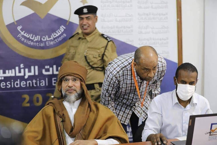ASSOCIATED PRESS
                                Seif al-Islam, left, the son and one-time heir apparent of late Libyan dictator Moammar Gadhafi registers his candidacy for the country’s presidential elections next month, in Sabha, Libya, today. Al-Islam, who was seen as the reformist face of Gadhafi’s regime before the 2011 uprising, was released in June 2017 after more than five years of detention.