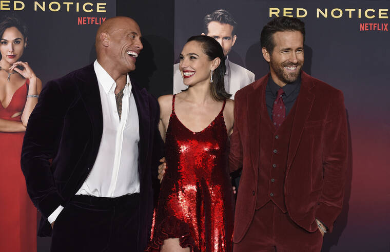 JORDAN STRAUSS/INVISION/ASSOCIATED PRESS
                                From left, cast members Dwayne Johnson, Gal Gadot and Ryan Reynolds arrived at the Los Angeles premiere of “Red Notice” at L.A. Live, Nov. 3.