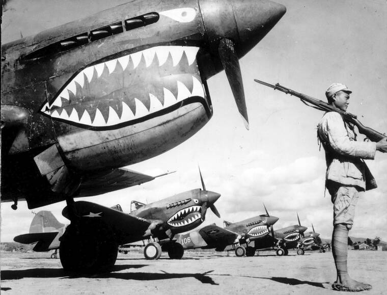 ASSOCIATED PRESS
                                Guarded by a Chinese soldier, a squadron of Curtiss P-40 fighter planes, decorated with the typical shark face of the famed Flying Tigers, are lined up at an unknown airbase in China in 1943. Veterans, historians and officials from China and the United States celebrated the 80th anniversary of the Flying Tigers, an air unit that delivered aid to Chinese troops fighting the Japanese military occupation during World War II. The meeting was a reminder of positive historic ties between China and the U.S. on the same day the two countries’ leaders spoke after years of rising tensions between the world’s largest economies.