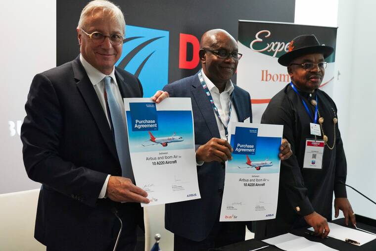 ASSOCIATED PRESS
                                Airbus chief commercial officer Christian Scherer, left, Nigeria’s Ibom Air CEO Mfon Udom, center, and Akwa Ibom state Governor Udom Gabriel Emmanuel, right, show a commemorative purchase agreement signed at the Dubai Air Show in Dubai, United Arab Emirates. Airbus said Tuesday it received an order of 10 narrow-body A220 jets from Nigeria’s Ibom Air, a new carrier owned by the oil-rich southeast state of Akwa Ibom.