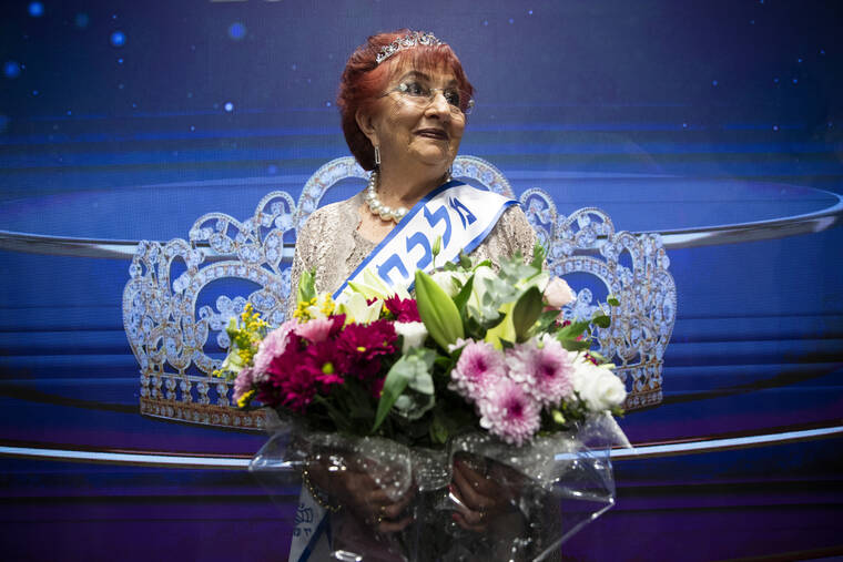 ASSOCIATED PRESS
                                Salina Steinfeld, 86, is crowned ‘Miss Holocaust Survivor’ poses for a photo during a special beauty pageant honoring Holocaust survivors in Jerusalem. Ten contestants participated in the pageant, which was held for the first time since 2019 after being suspended due to the coronavirus pandemic.