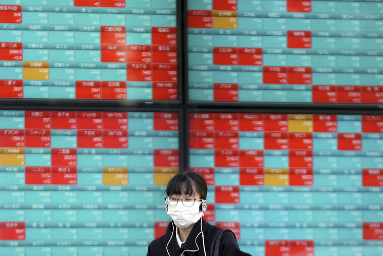 ASSOCIATED PRESS
                                A woman wearing a protective mask stands in front of an electronic stock board showing Japan’s Nikkei 225 index at a securities firm in Tokyo. Asian shares mostly declined Thursday after stock indexes shuffled lower on Wall Street.