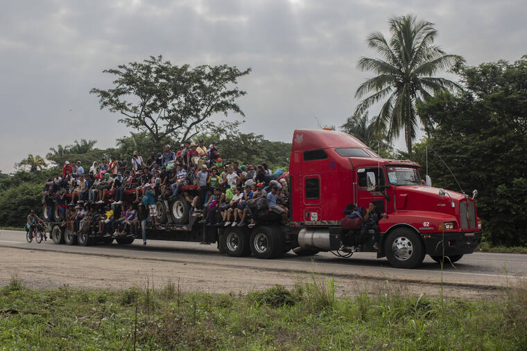 ASSOCIATED PRESS
                                Migrants are transported on the bed of a trailer in Jesus Carranza, in the Mexican state of Veracruz. A group of mainly Central American migrants are attempting to reach the U.S.-Mexico border.