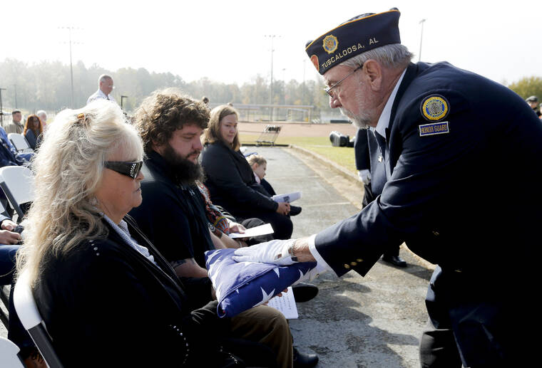 TUSCALOOSA NEWS VIA AP
                                American Legion Post 123 honor guard commander Stanely Blevins presented an American flag to the Jones brothers’ niece Jamie Jones.