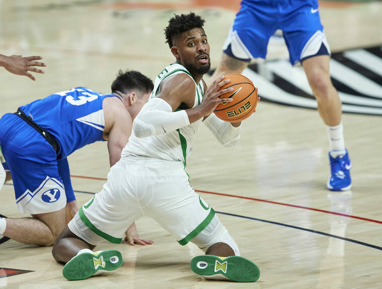 ASSOCIATED PRESS
                                Oregon forward Quincy Guerrier, right, looks to pass the ball from next to BYU’s Alex Barcello during the second half of an NCAA college basketball game in Portland, Ore., on Nov. 16.
