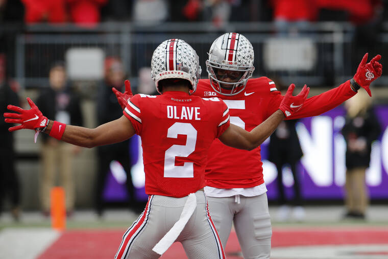 ASSOCIATED PRESS
                                Ohio State receiver Garrett Wilson, right, celebrates his touchdown against Michigan State with teammate Chris Olave during the first half of an NCAA college football game Saturday in Columbus, Ohio.